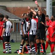 Leighton Thomas, centre, is shown red by referee Paul Barber