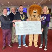 Lions Trevor Stratton, John Davies, President Ryan Hope, Kevin the Lion and Sally Smith, Grants Partnership Manager at Home-Start Wessex