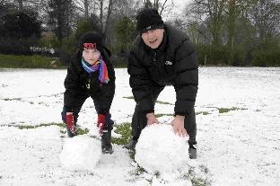 Kevin Davies with his son Oliver making a snowman at Charlton Down.