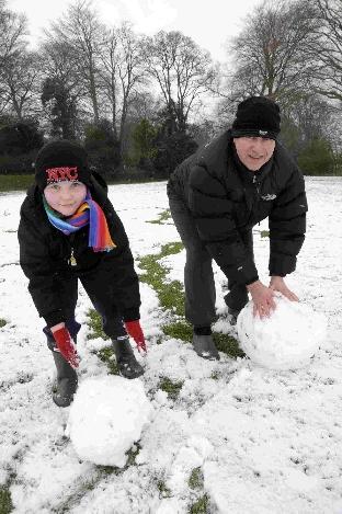 Kevin Davies with his son Oliver making a snowman at Charlton Down.