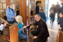 Father Anthony O'Gorman with one of the special visitors attending the pet service at Our Lady Star of the Sea church in Weymouth