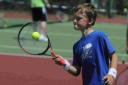 ON COURT: A Year Four pupil focuses on returning the ball at the tennis festival