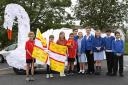 Torch bearers from Radipole hand over to Southill Primary, in front of the swan car