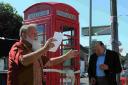 NUMBER’S UP: Arthur Copus and Dennis Fancy open the phone kiosk