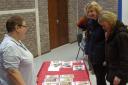 Stallholder Linda Crowe shows interested customers some of her selection of home made cards