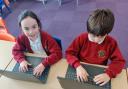 Lulworth and Winfrith C of E Primary School pupils using laptops