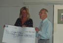 Annette Plaistow-Trapeud accepts the cheque from Reginald Thompson of the Holly Court residents.