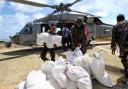 RELIEF WORK: Filipino police officers and soldiers unload relief goods for Typhoon Haiyan