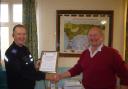 Peter Jones presents the certificate to PCSO Clive Joyner
