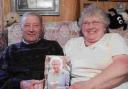 Diamond wedding couple Alfie and Olive Barnes with their greeting from the Queen