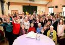 MANY HAPPY RETURNS: Winifred True celebrates her 100th birthday, seated centre in red