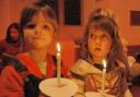 Left, Emma Clegg and right, Rose Clark, both from Milborne St Andrew First School hold their candles for Advent       Picture: Roy Bennet from Puddlet