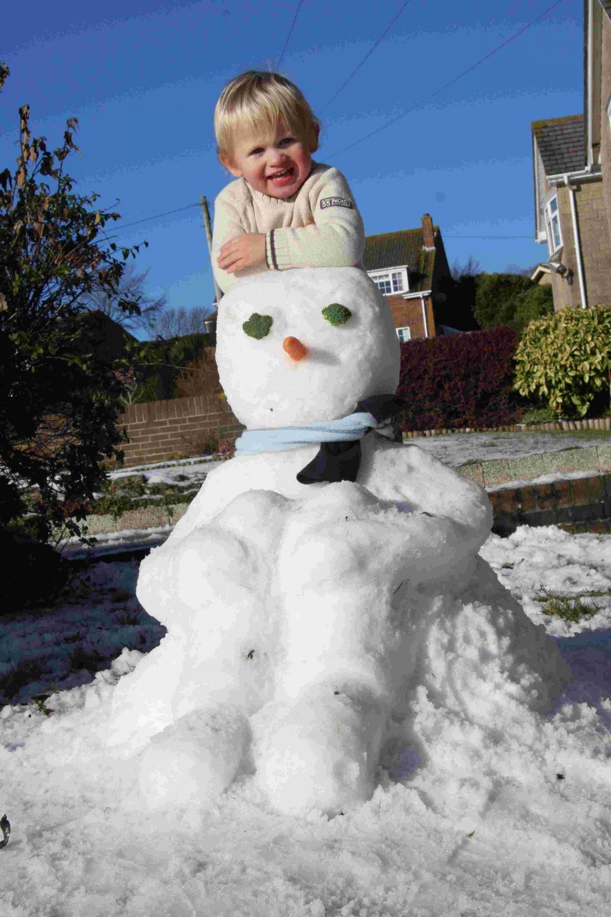 Oscar Smith, two, with his snowman at Preston, Weymouth