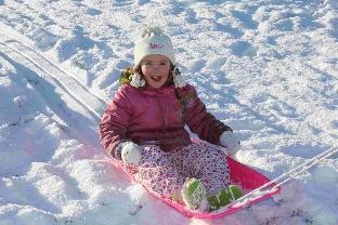 Isobel Griffiths makes the most of the snow on her sledge at Bumpy Fields in Lyme Regis Pic by Victoria White
