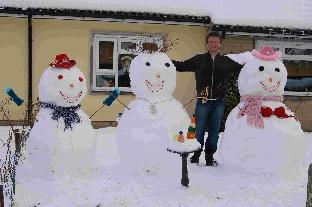 Bryan Lavelle with his snowmen in Cerne Abbas
