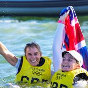 Hannah Mills, left, and Eilidh McIntyre celebrate in the water after winning gold at Tokyo 2020 Picture: SAILING ENERGY/WORLD SAILING
