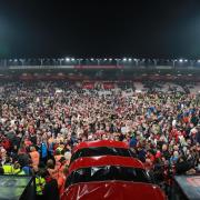 AFC Bournemouth supporters on the pitch at Vitality Stadium after promotion to the Premier League was secured. Picture: Richard Crease