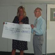 Annette Plaistow-Trapeud accepts the cheque from Reginald Thompson of the Holly Court residents.