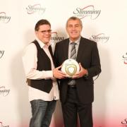 Slimming champ Simon receives his award from Shilton