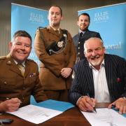 Ellis Jones Solicitors has signed the Armed Forces Covenant. Lieutenant Colonel Anthony Sharman of the British Army (left) and Managing Partner Nigel Smith (right) put pen to paper watched by Conor Maher (left) and Will Dooley (right)