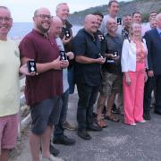 the RNLI Lyme Regis crew with their jubilee medals. Centre, the Mayor, Cllr Michaela Ellis and her her consort, her husband Alan.