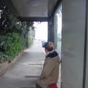 Anne White waits for the bus in the smart new shelter.
