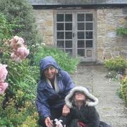 Hazel and grandaughter Freya brave the raain in The Gatehouse garden