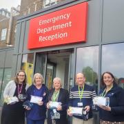 Annette Kent, Vice-Chair of the Friends of Dorset County Hospital (centre) and Paul Kent, Treasurer of the Friends of Dorset County Hospital (second from the right) presenting the comfort bags to DCH staff outside the Emergency Department