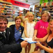 Co-Op store manager Mark Whatley and shopper Sue Hine with Sarah Edwards and children Molly Lomax and Abigail Webster