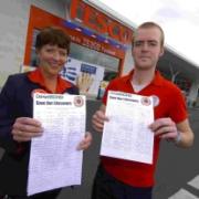 Portland Tesco staff members Lyn Higham and Roscoe Neal with the petition at the store in Easton