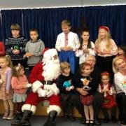 Cllr Hewitt with Father Christmas and Ukrainian children at the Dorford Centre last year
