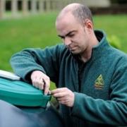 An OFTEC registered technician inspects a customer’s domestic oil tank