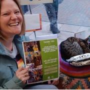 Suzy's owner, Jenny Graves, with Suzy in Oxfam Dorchester's shop window