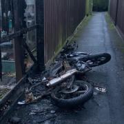 The motorbike was on fire down an alleyway close to homes