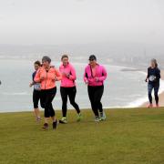 Runners on the scenic Weymouth Bay 10k course
