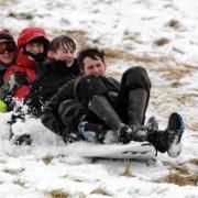 Sledding with surfboard in the snow at Sutton Poyntz