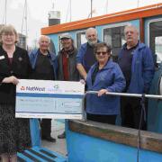 THANKS A LOT: Representatives of Highclere House present £500 to the Friends of MV Freedom