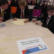 SHARING IDEAS: Pupils discuss the school