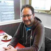 TAKING TEA: Chris Chibnall  enjoys Eccles cake and tea at the Watchhouse Cafe, West Bay as filming for the second series ends