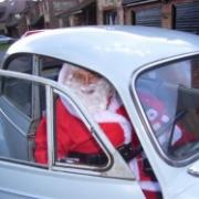 Santa sets off in a Morris Minor for the ladies' circle fair