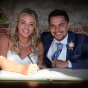 SIGN ON THE DOTTED LINE: Emma and Jonny married at last Photograph: CHRIS WHITEFIELD WEDDINGS