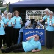 Crossways handbell ringers at Wool carnival with the conductor and Echo correspondent on the floor