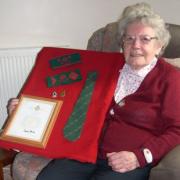 Doris Greening proudly displays her land army mementoes, medal and certificate