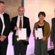 HONOUR: Patrick Charlton and Rosalyn Guard of Environs Partnership receive awards from Nick Crane, right
