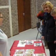 Stallholder Linda Crowe shows interested customers some of her selection of home made cards