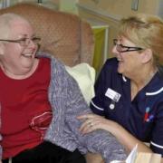 FRIENDS INDEED: Senior sister Sally-Anne Baverstock enjoys a laugh with patient Pamela Morris