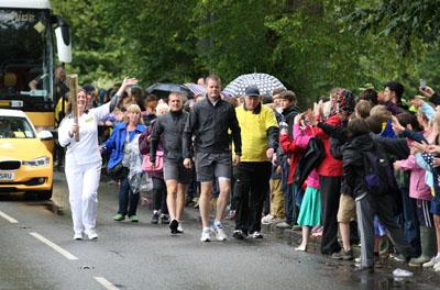 Trudy Davies carries the Olympic Flame on the Torch Relay leg between Dorchester and Winterbourne Abbas. 