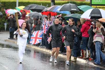  Katie Norman carries the Olympic Flame on the Torch Relay leg between Bridport and Lyme Regis. 