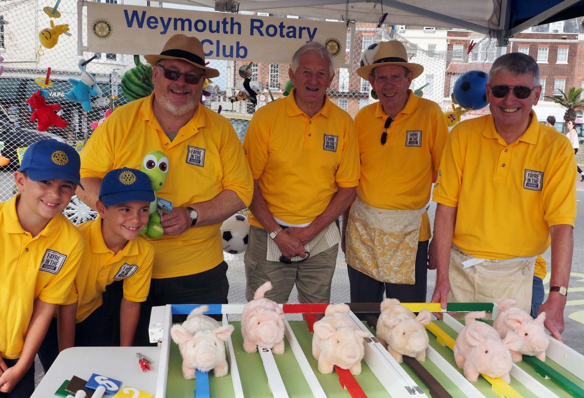 Members of the Weymouth Rotary Club running the pig race on the Esplanade Photograph: Dorset Media Service