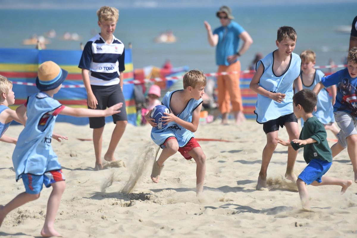 HAVE A GO: Children play touch rugby on Weymouth beach